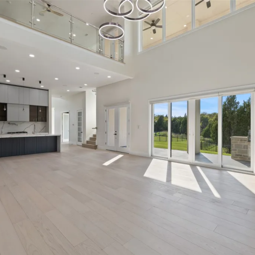 Texas Luxury full house custom in America 9 Open plan living room with custom kitchen cabinetry and aluminum sliding doors overlooking patio