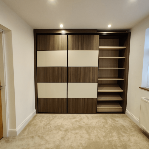 wardrobe shelving behind sliding panel with adjustable wooden shelves