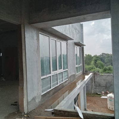 Wide view of a white aluminum window installed in the villa in Bogor, Indonesia, complementing the modern exterior design.