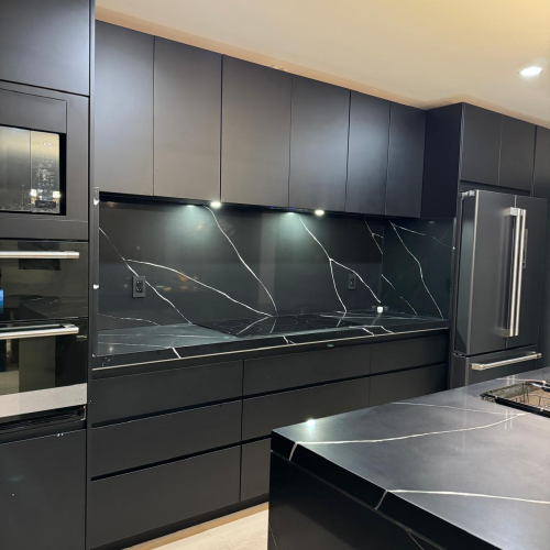 Custom cabinet in Los Angeles kitchen with black finish and high-end appliances.