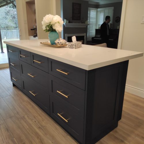custom kitchen cabinet Canada with a large kitchen island featuring marble countertops