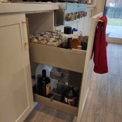 custom kitchen cabinet Canada, modern gold handle close-up, sleek kitchen appliance setup.