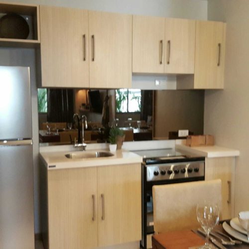 280 Units Philippines Hotel Project 5 A custom kitchen cabinet with Refrigerator,beside the dining area,howcasing a hotel kitchen design in the Philippines.