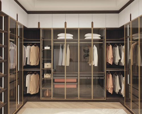 Modern Walk In Wardrobe with Glass Doors and Island showcasing multiple hanging zones and storage drawers
