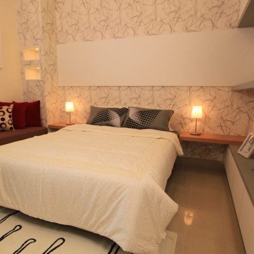 A custom nightstand with a sleek, modern design, providing functional storage beside a bed.