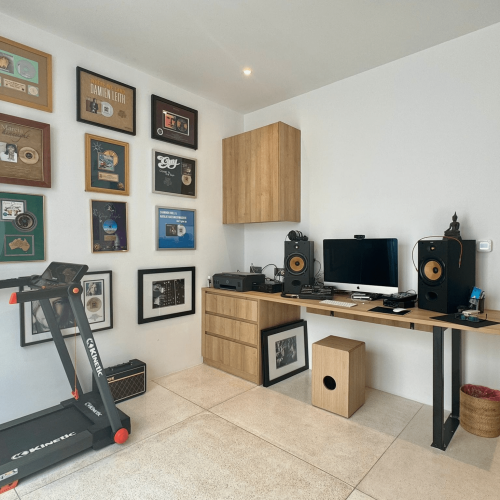 Music setup with sound speakers and a treadmill in Bali project room.