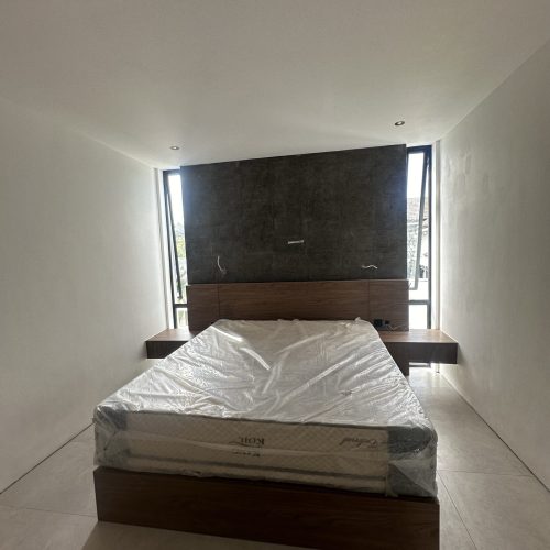 Umalas Creek Villa Custom Cabinets Project bedroom headboard with integrated wood panel and floating nightstands