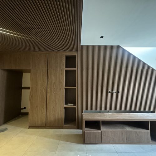 Umalas Creek Villa Custom Cabinets Project living room media wall with slatted panel and walnut veneer console