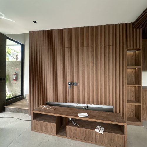 Umalas Creek Villa Custom Cabinets Project slatted wood media wall with custom walnut veneer console