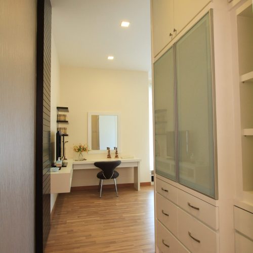 Custom wardrobe and vanity in a stylish Malaysian hotel room.