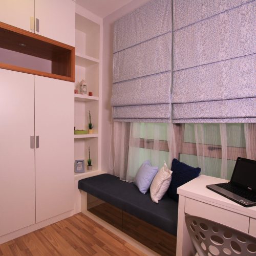Custom wardrobe in a modern hotel room, designed for efficient storage and sleek appearance.