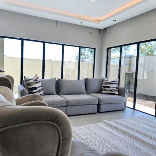 imbabwe full house custom living room with contemporary furniture and natural light.