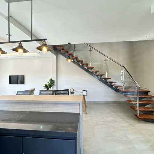 Zimbabwe full house custom kitchen interior featuring modern design with bar stools and elegant lighting.