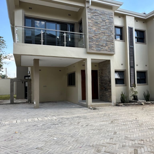 Exterior view of a custom-built home in Zimbabwe featuring modern architecture and clean lines